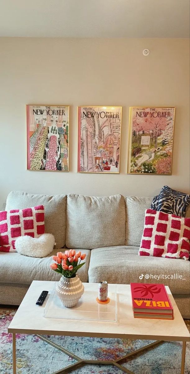 a living room filled with furniture and pictures on the wall above it's coffee table