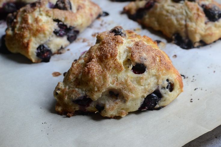 blueberry scones are sitting on a baking sheet