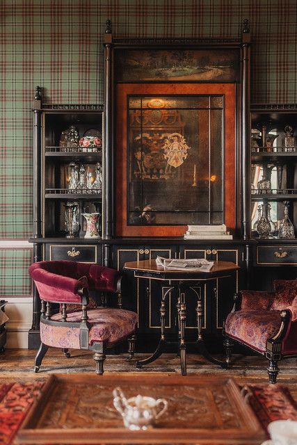 a living room filled with furniture and a painting on the wall