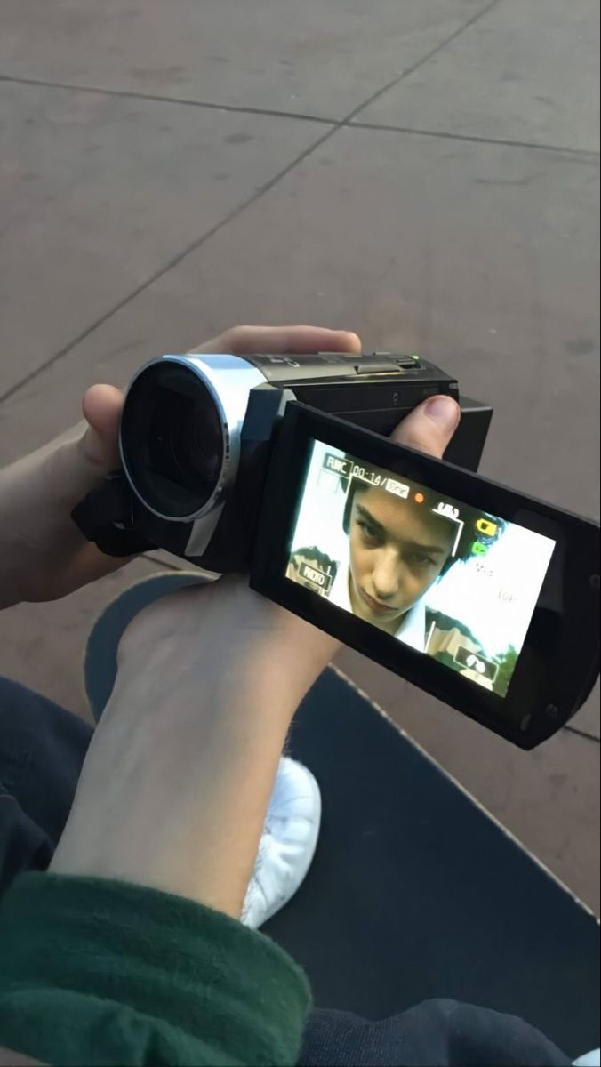 a person holding up a camera to take a photo