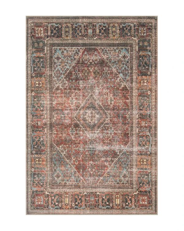 an orange, blue and brown rug with ornate designs on the bottom half of it