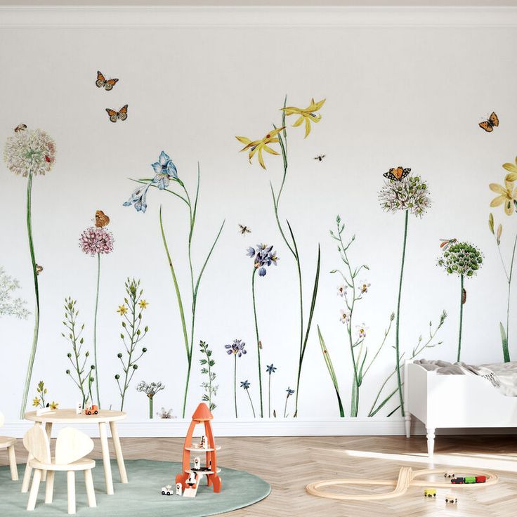 a child's room with flowers and butterflies painted on the wall