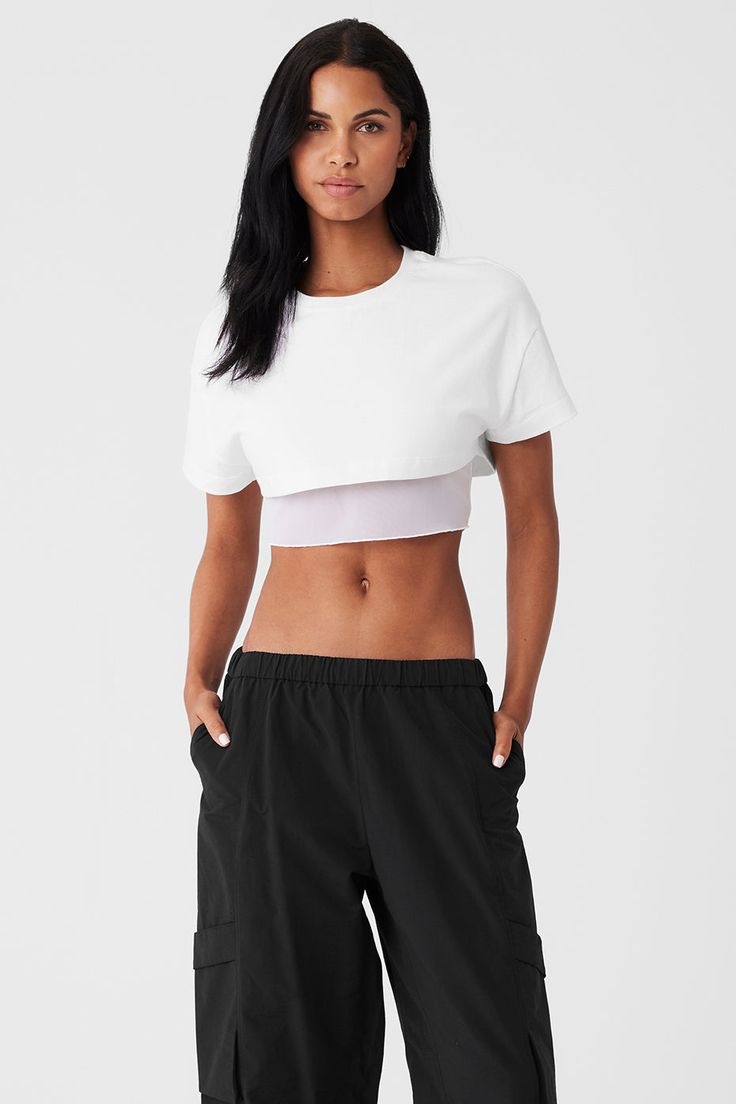 Designed with a boxy, heavyweight cotton top and a tight mesh lining that hits at the ribcage, this is the studio-to-street crop you’ll wear nonstop. This easy silhouette lends a ’90s vibe to any outfit—throw it on over a workout set on the way to yoga or pair it with trousers for a cool city look. Alo Yoga Relaxed Fit Cotton Top, Spring Cropped T-shirt For Workout, Sporty Crop Top For Summer Layering, Sporty Crop Top For Layering, Alo Yoga Relaxed Fit Athleisure Top, Sporty Boxy Fit Tops For Layering, Summer Athleisure Crop Top For Layering, Sporty Layering Crop Top, Athleisure Crop Top For Spring Layering