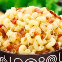 a bowl filled with macaroni and cheese on top of a table