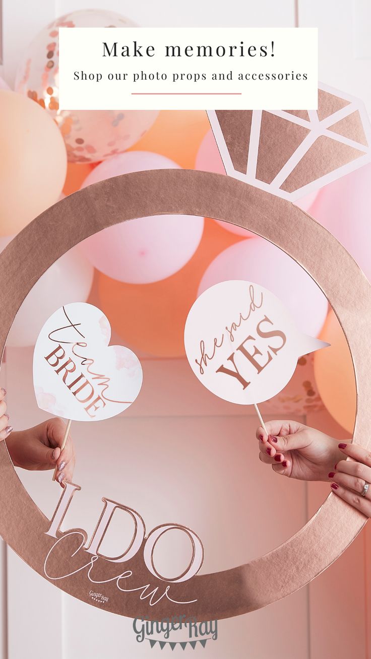 two people holding up signs in front of balloons