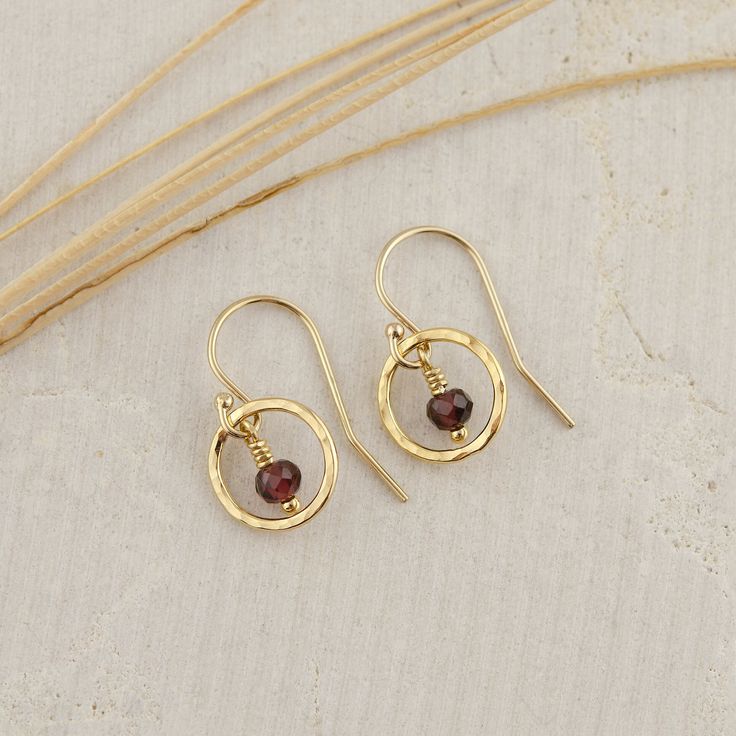 This extremely sweet pair of Small Red Garnet Circle Earrings are handcrafted for you with great care. The earring is lightweight, simple, and pretty. They are perfect for everyday wear and are a great January birthday gift! MATERIALS AND SIZE  ◆ Metal - 925 Sterling Silver, 925 Sterling Silver. ◆ Earrings measure approx. 0.75 inches / 19 mm from the top of the ear wire ◆ All earrings with French ear wires come with silicone ear backs for extra protection. ◆ Because I am using natural stones, th Yellow Gold Garnet Round Earrings, 14k Gold Filled Round Earrings For Gift, Garnet Drop Earrings As Gift, Gold Garnet Teardrop Earrings, Gold Teardrop Garnet Earrings, Yellow Gold Garnet Earrings For Gift, Yellow Gold Garnet Earrings For Anniversary, Handmade Oval 14k Gold Filled Earrings, Garnet Drop Earrings For Gifts