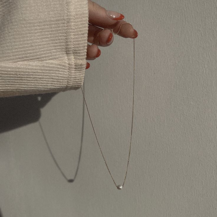 Classic to her core. Delicately strung on a delicate curb link chain, dainty freshwater pearl rests sweetly on the décolleté and is designed to wear with any and everything, all the time. How we style our necklaces: Created to layer with all our pieces, the style-outs are endless and effortless. We love to layer our pendants with our shorties and 20” necklaces. If layering isn’t your thing, no worries! Complete the solo look with a solid wrist stack and a midi ring. Best worn with a glowing smil Pearl Charm Necklace With Clavicle Chain, Pearl Clavicle Chain Charm Necklaces, Simple Necklace With Delicate Chain For Layering, Simple Delicate Chain Necklace For Layering, Classic Charm Necklace With Delicate Chain For Everyday, Minimalist Delicate Chain Charm Necklaces For Layering, Minimalist Delicate Chain Necklaces For Layering, Everyday Delicate Chain Necklace, Elegant Chain Necklace For Layering