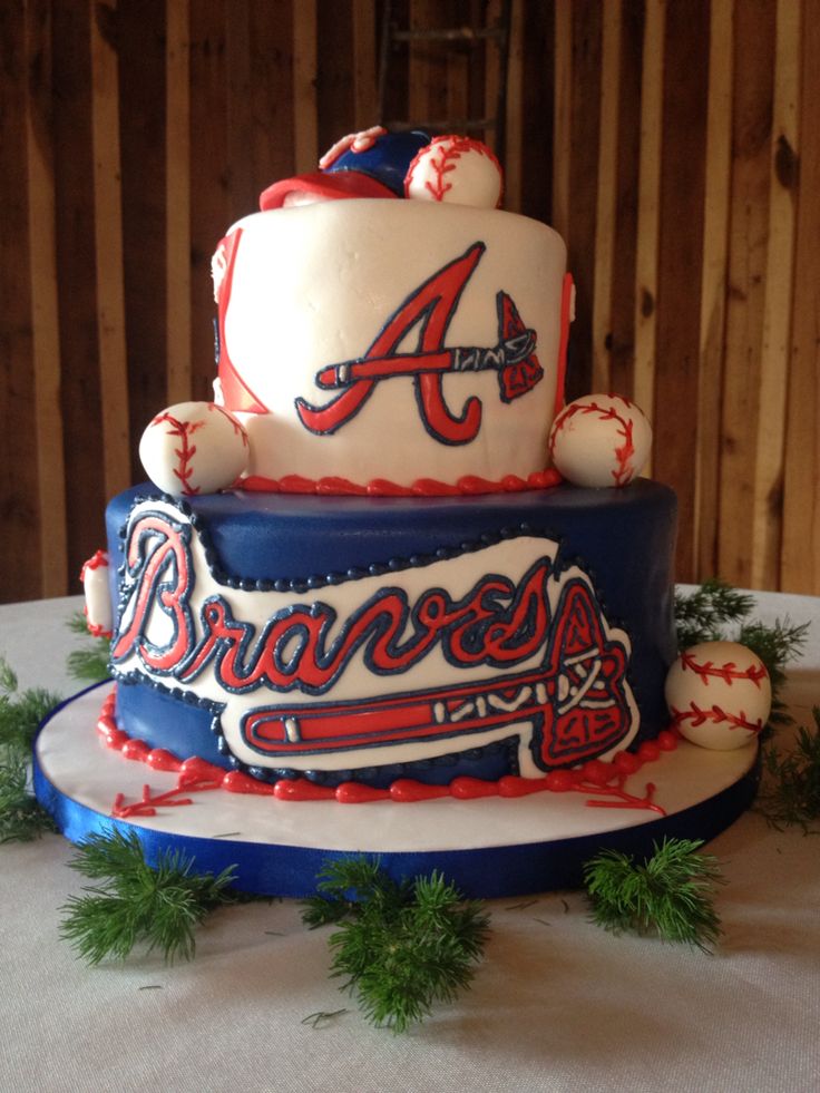 a three tiered cake is decorated with baseballs and the word braves on it