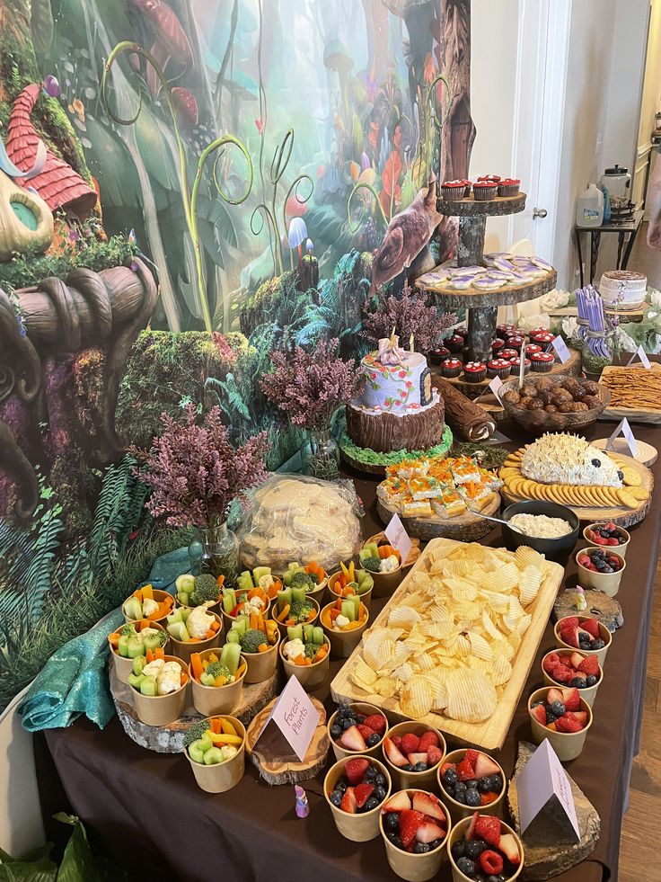 a buffet table filled with lots of different foods and desserts on it's sides