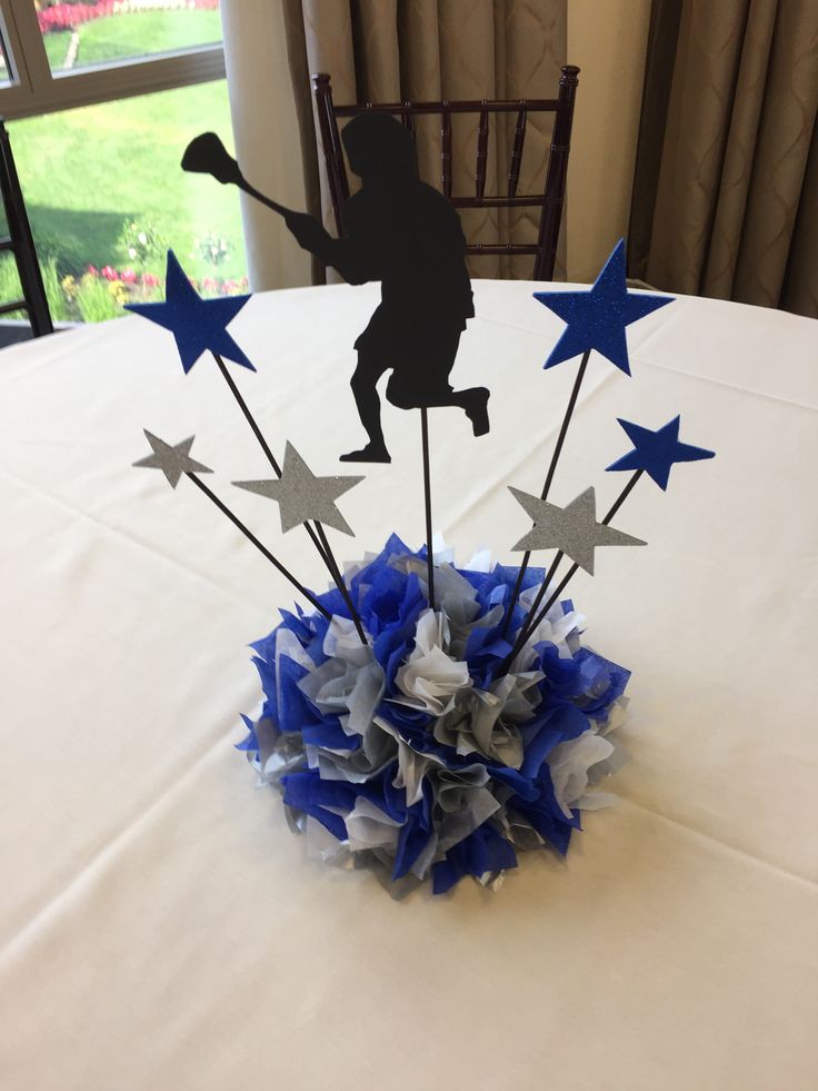 a table topped with blue, white and silver stars on top of a cloth covered table