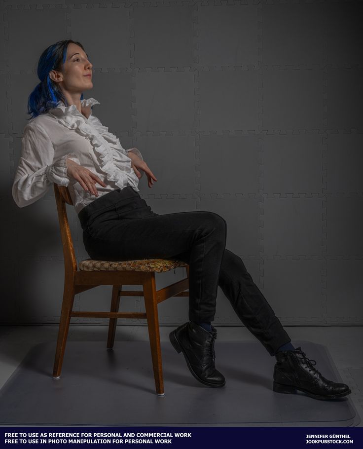 a woman with blue hair sitting on a chair