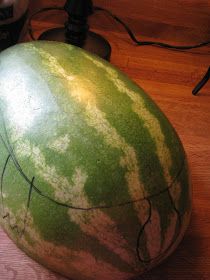 a large watermelon sitting on top of a wooden table