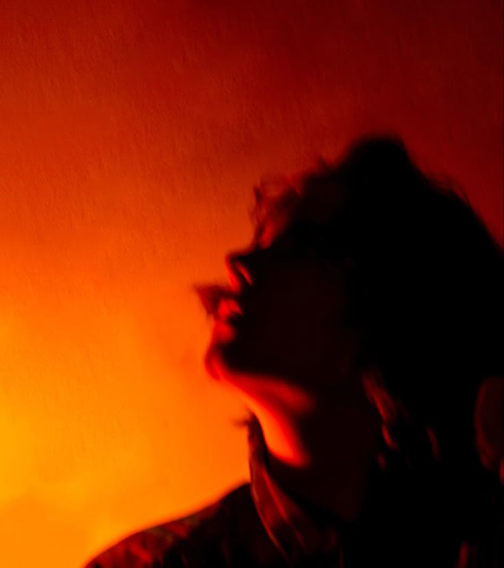 Woman with dark shadows and red, yellow, orange lighting photography Orange Lighting Portrait, Orange Light Photography, Orange Photography Aesthetic, Orange Light Photoshoot, Orange Lighting Photography, Red Lighting Aesthetic, Orange Dark Aesthetic, Orange Light Aesthetic, Deep Orange Aesthetic