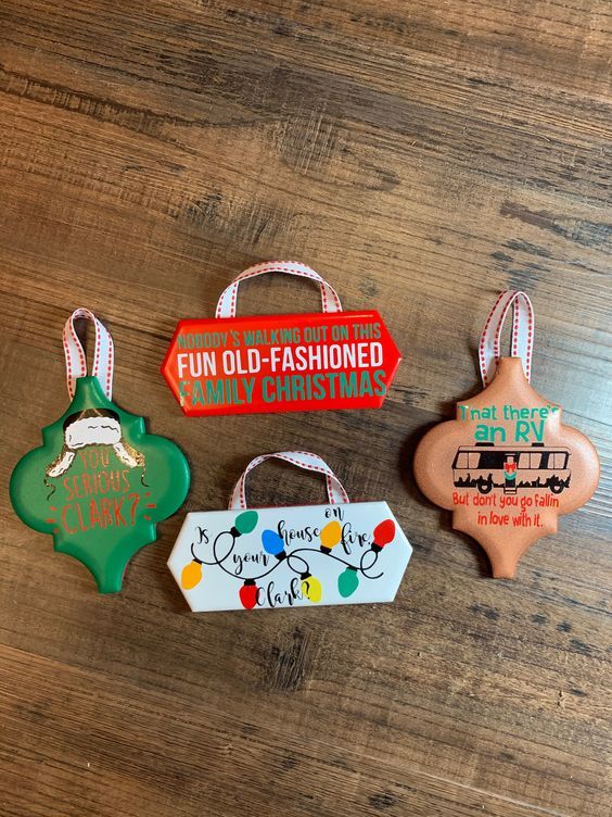 three christmas ornaments on a wooden table