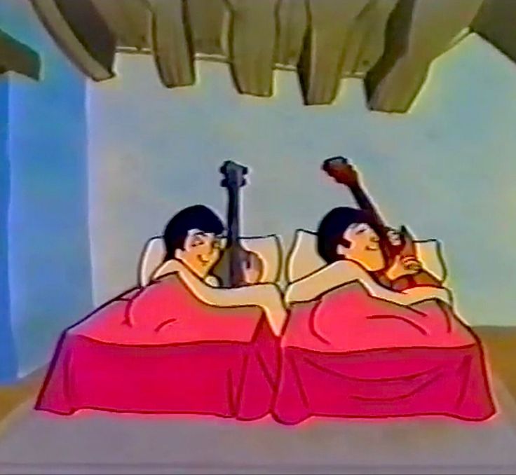 two people laying in bed with guitars on their backs