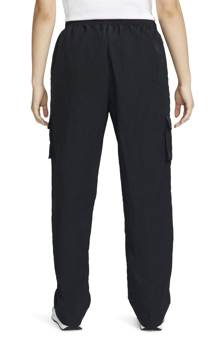 Cargo pockets and a relaxed fit give your off-duty look a utilitarian finishing touch in woven sweatpants finished with an adjustable drawcord waist. 100% nylon Machine wash, tumble dry Imported Cargo Trousers, Nike Black, Nike Sportswear, Black Nikes, Cargo Pants, Casual Pants, Nike Women, High Rise, Sweatpants