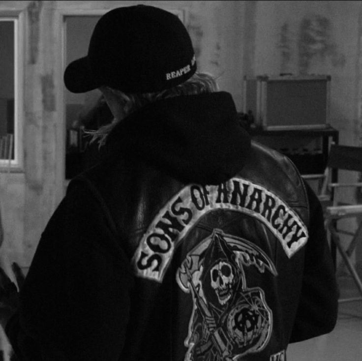 a person wearing a black jacket with a skull on it