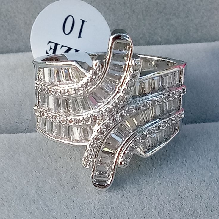 18k White Gold Over Silver Quality Made Zirconia Fashion Statement Ring. *Beautifully Designed Quality Jewelry That Last A Lifetime. Size 7, 8, 9, 10 Gift Box Fast Shipping *See More Beautiful Jewelry In White Baguette Diamond Jewelry For Anniversary, Anniversary Jewelry With Baguette Diamonds In Diamond White, White Cubic Zirconia Diamond Ring With Accents, Anniversary Diamond White Baguette Jewelry, Anniversary Baguette Diamond White Jewelry, Sterling Silver Baguette Diamond Ring For Anniversary, Sterling Silver Diamond Ring With Baguette Diamonds For Anniversary, Anniversary Sterling Silver Ring With Baguette Diamonds, Anniversary White Gold Crystal Ring With Cubic Zirconia