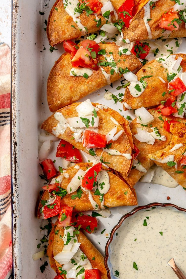 a tray filled with pizza and dip