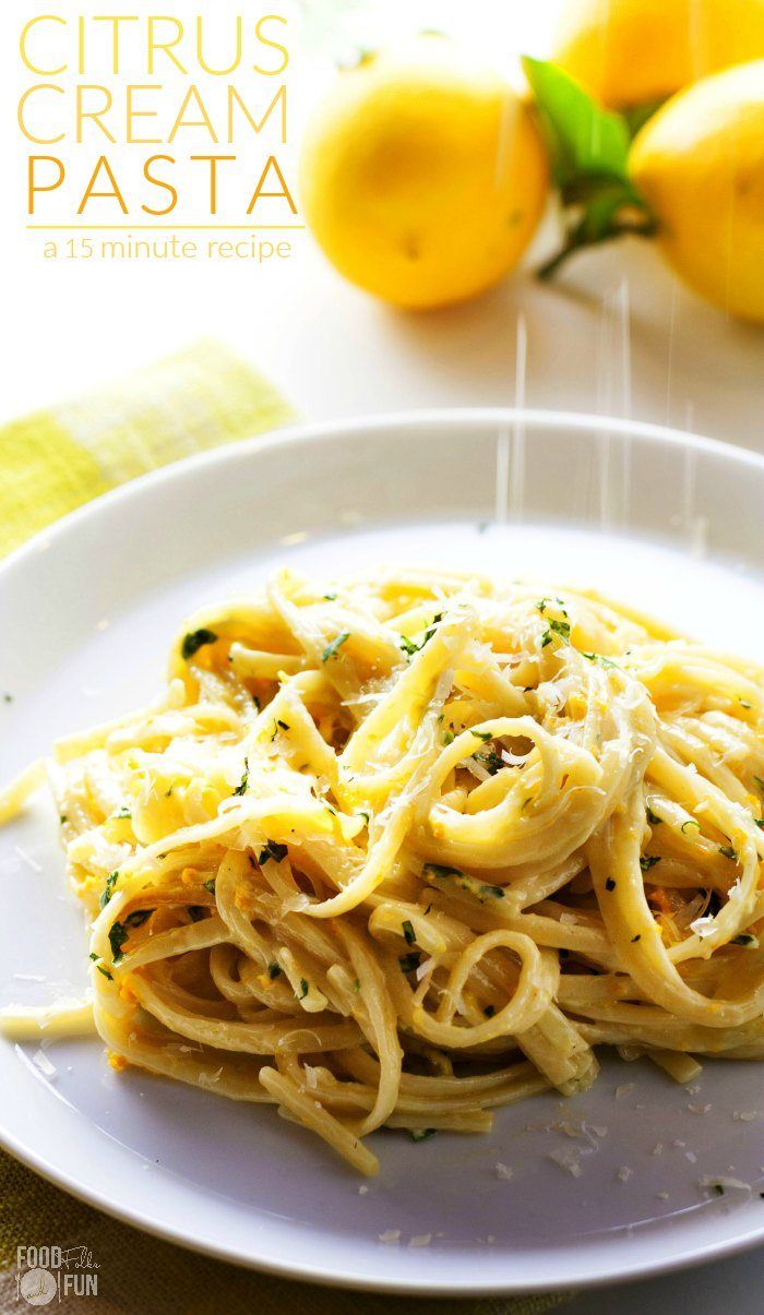 a white plate topped with pasta and lemons