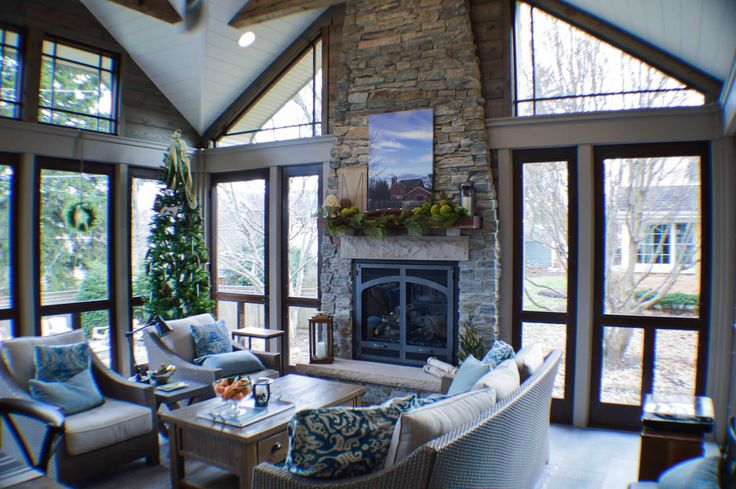 a living room filled with lots of furniture next to a fire place in a house