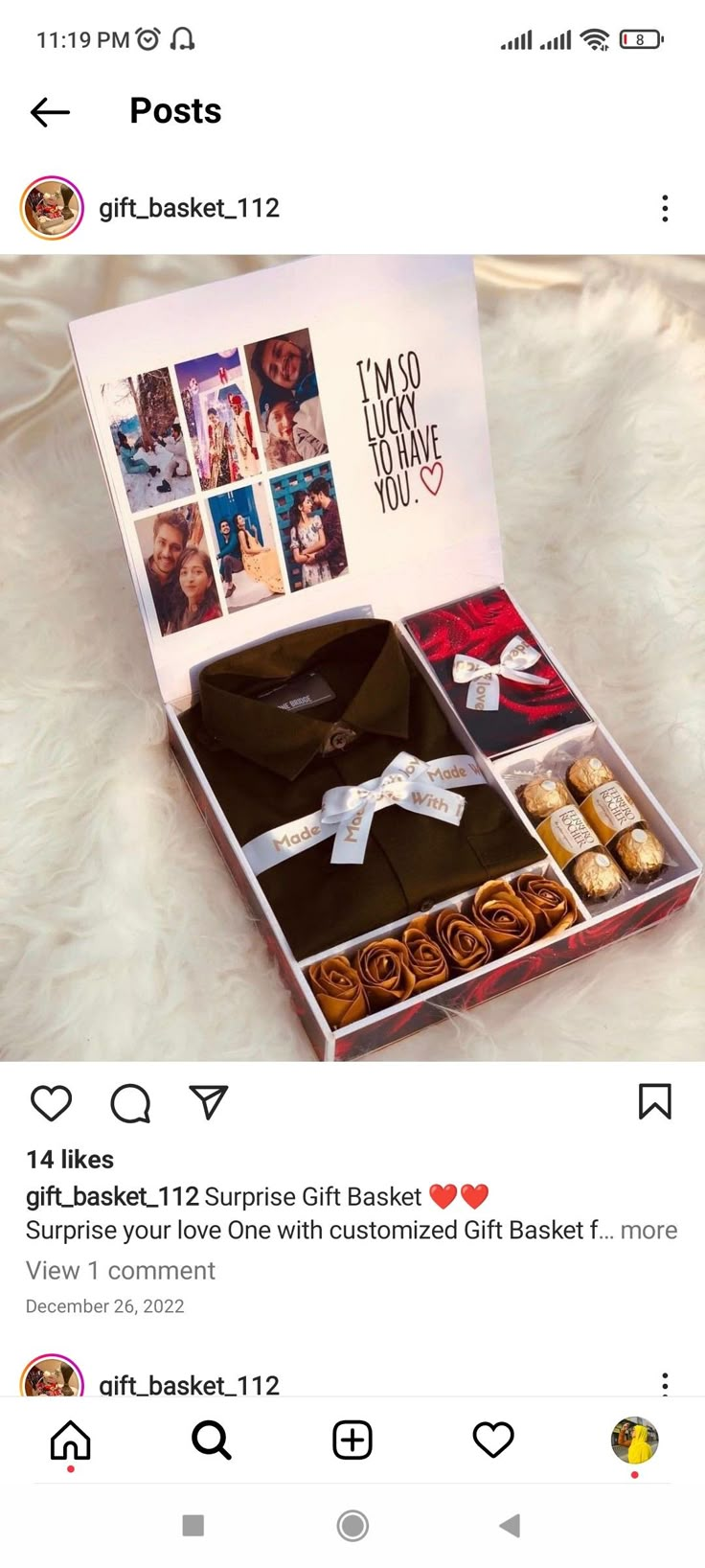 an open gift box with pictures on the front and inside, sitting on top of a bed