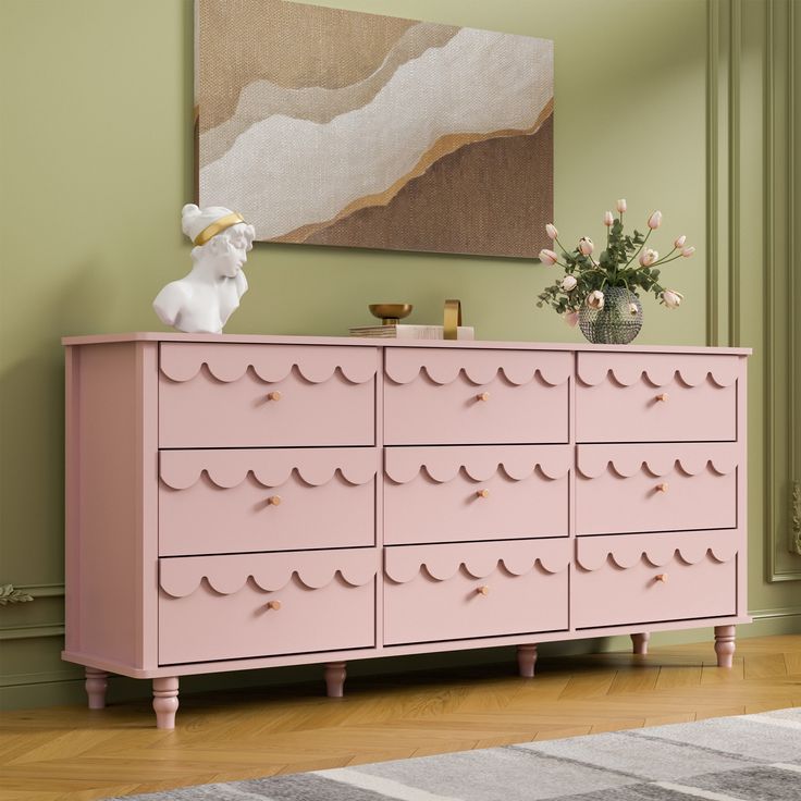 a pink dresser with lots of drawers in a room