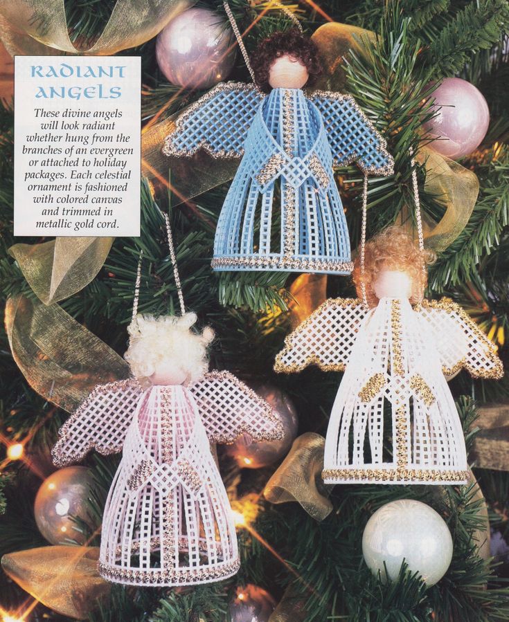 two angel ornaments hanging from a christmas tree