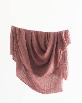 a pink scarf hanging on a clothes line