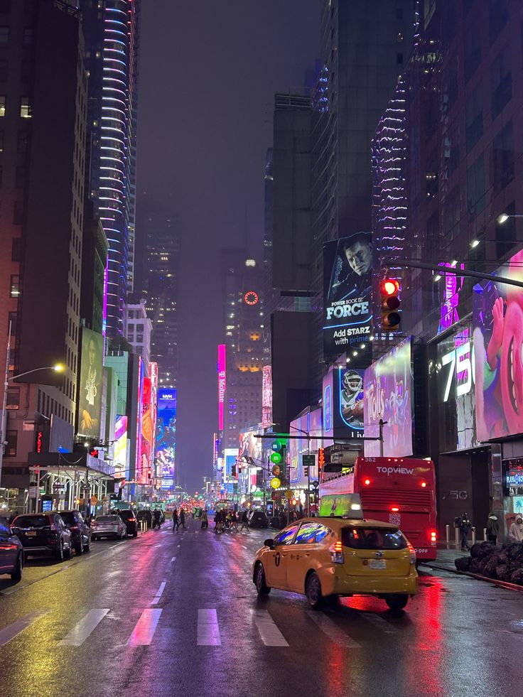 a busy city street at night with neon signs and buildings on both sides, cars driving down the road