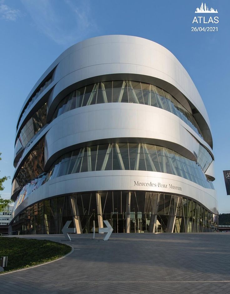 a modern building with curved glass and steel