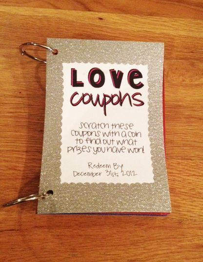 a love coupon on a wooden table with two keys in front of it and the words love coupons