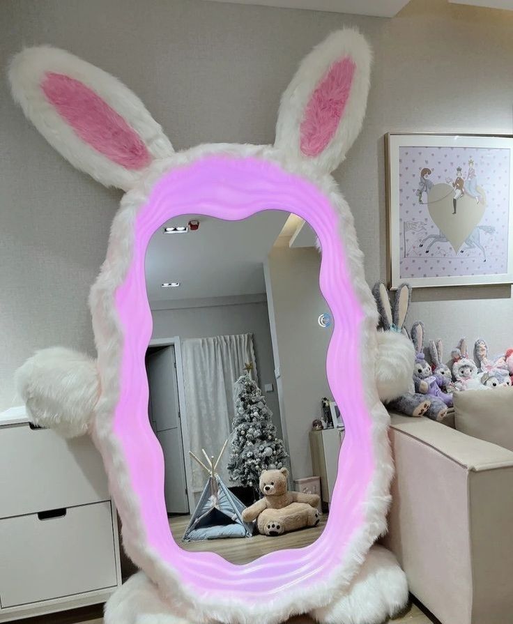 a mirror with bunny ears on it in the middle of a room