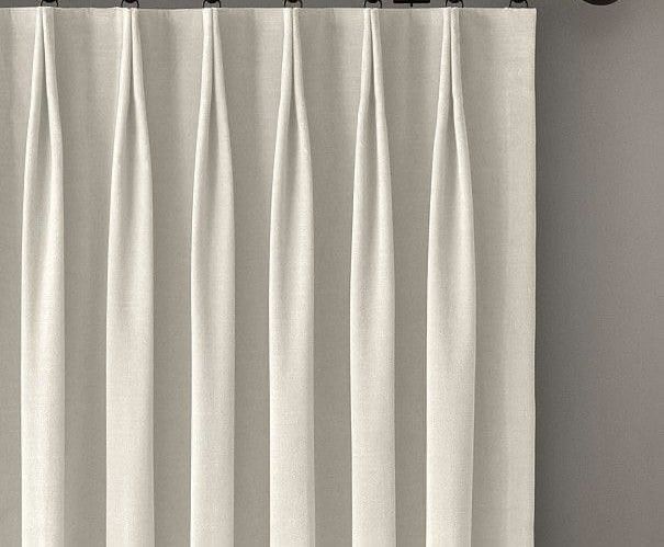 a white curtain hanging on the side of a wall next to a window sill