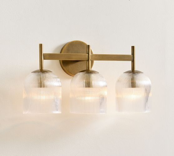 three lights on a wall mounted fixture