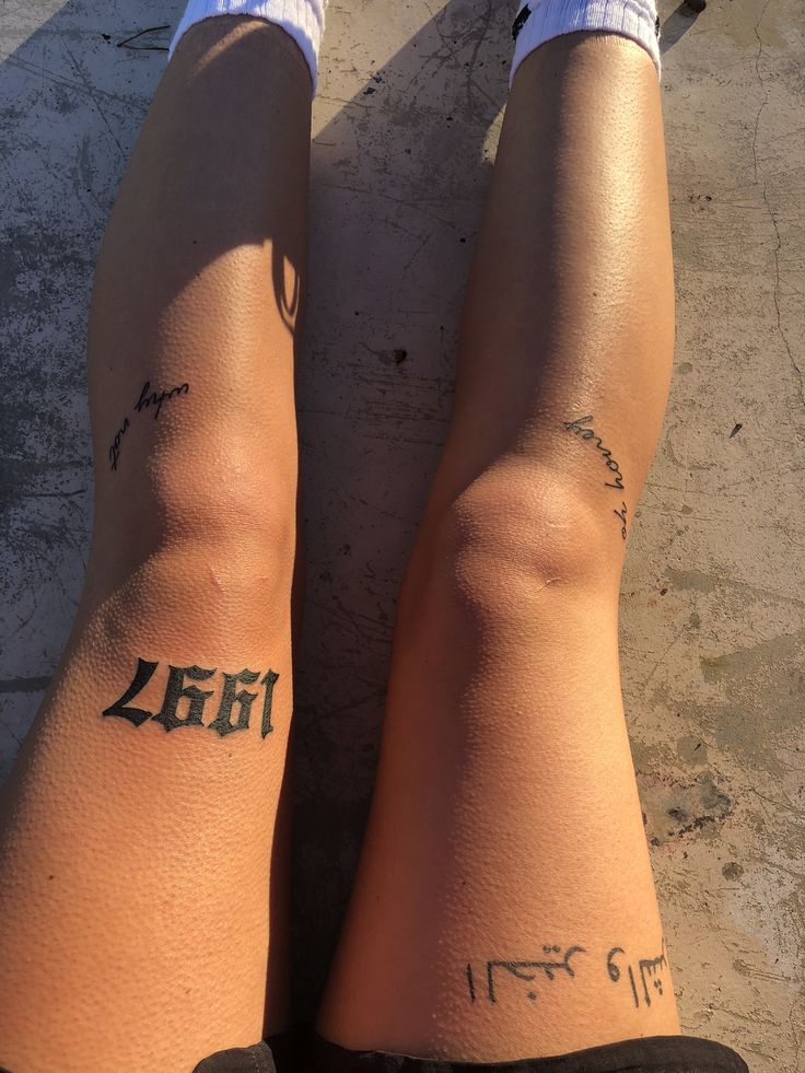 the legs of a person with tattoos on them