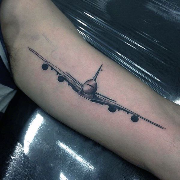 an airplane tattoo on the arm