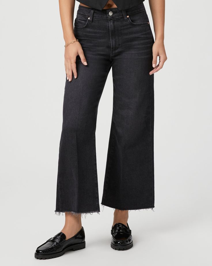 This modern high-waisted wide leg has an easy, relaxed fit and an ankle length silhouette. This style is cut from our PAIGE Vintage denim and comes in a vintage black wash with whiskering, fading, and a raw hem. PAIGE Vintage takes all of the work out of breaking in your favorite pair of vintage jeans. We've combined the comfort of stretch with everything you love about authentic vintage denim to create super soft jeans that feel perfectly lived-in from the very first wear. | Anessa Wide Leg Jea Chic High Rise Washed Black Bottoms, Black Wide Leg Pants With Frayed Hem, Black High Rise Pants With Frayed Hem, Chic Wide Leg Flare Jeans In Washed Black, Frayed Hem Cropped Wide Leg Pants For Fall, Chic Cropped Dark Wash Wide Leg Pants, High Rise Black Cropped Jeans For Fall, Black High Rise Cropped Jeans For Fall, Trendy High Rise Wide Leg Pants With Frayed Hem