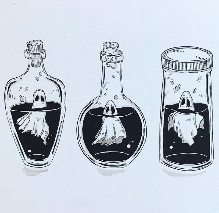 three bottles filled with liquid and ghost heads in them, one has a ghost's head hanging from the top