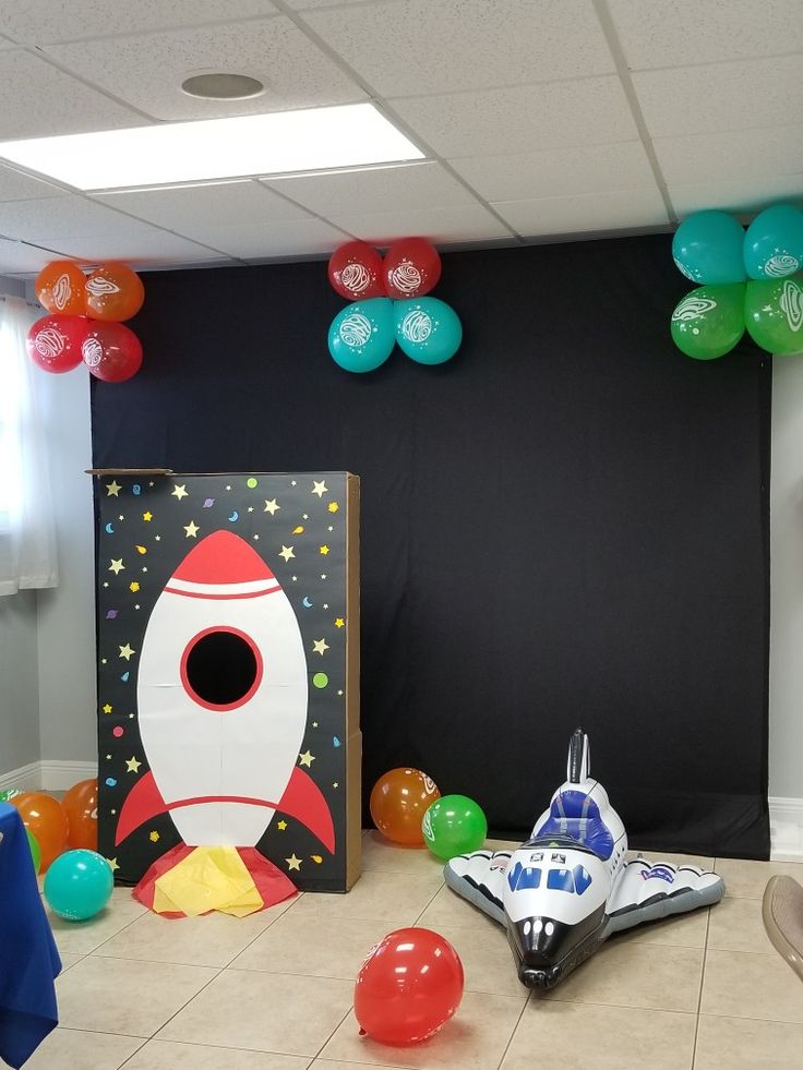 an office decorated with balloons and decorations for a space themed birthday or baby's first birthday