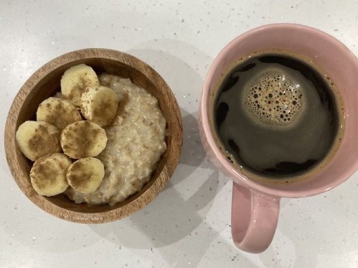 a bowl of oatmeal next to a cup of coffee