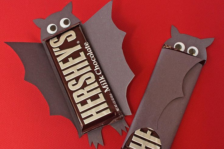 two chocolate bars with eyes and bats on them