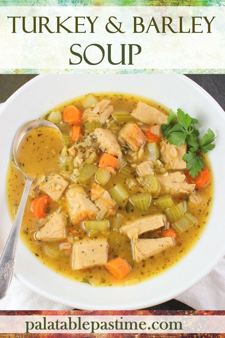 turkey and barley soup in a white bowl with a spoon