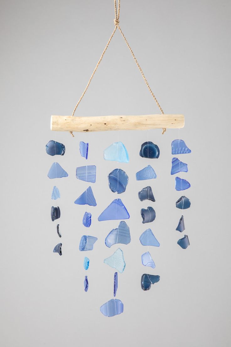 a wind chime with blue glass pieces hanging from it