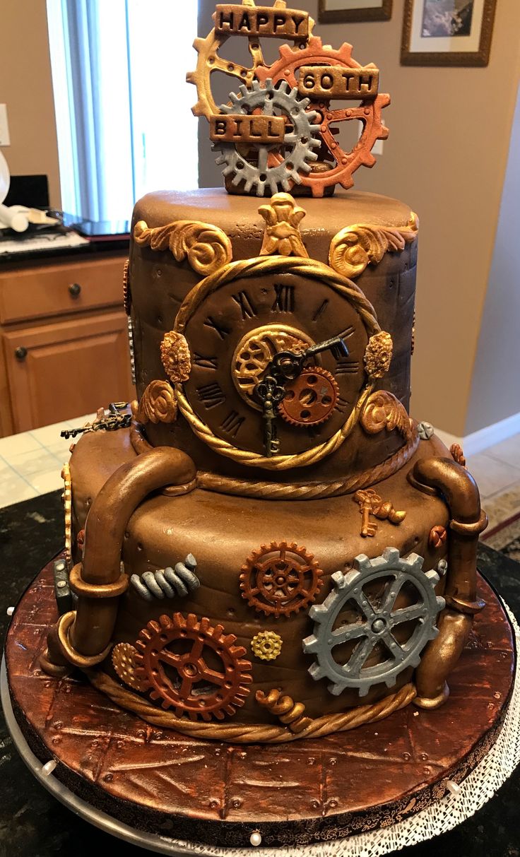 a three tiered cake with gears on it