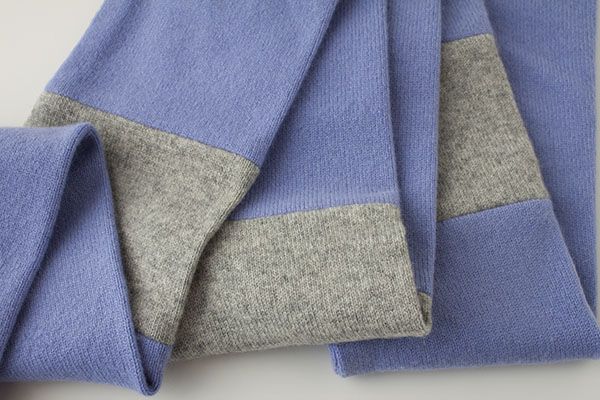 blue and grey sweaters folded on top of each other with two different colored sides