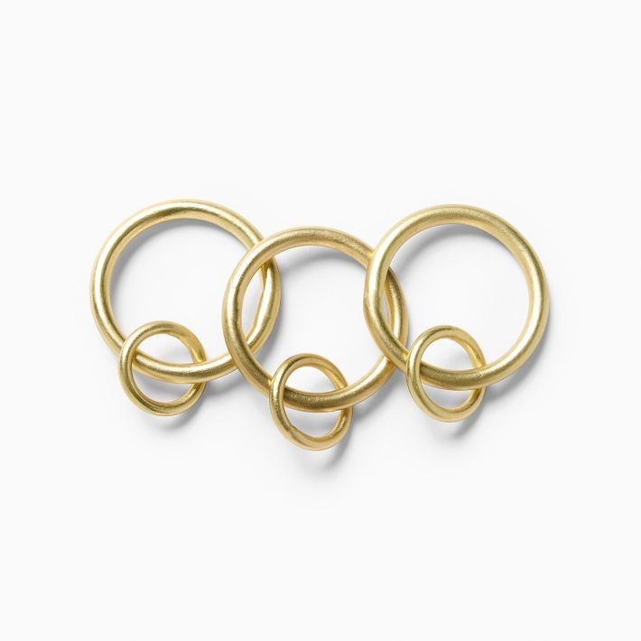 three gold rings on a white background with the word love spelled in it's center