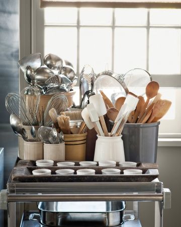 pots and pans are stacked on top of the stove with utensils in them