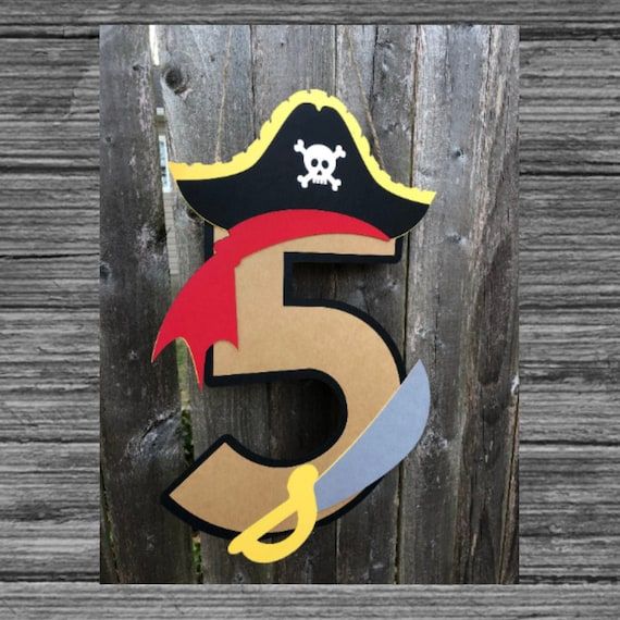 a wooden sign with a pirate hat and scissors on it's side that says 5