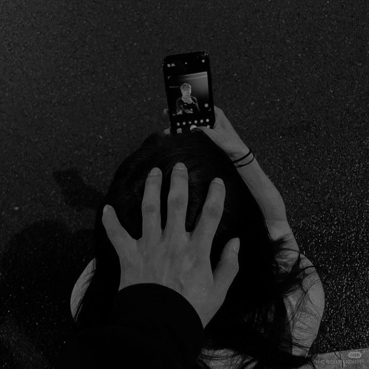 a black and white photo of someone taking a picture with their cell phone